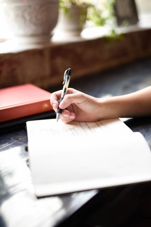 Woman writing in notepad