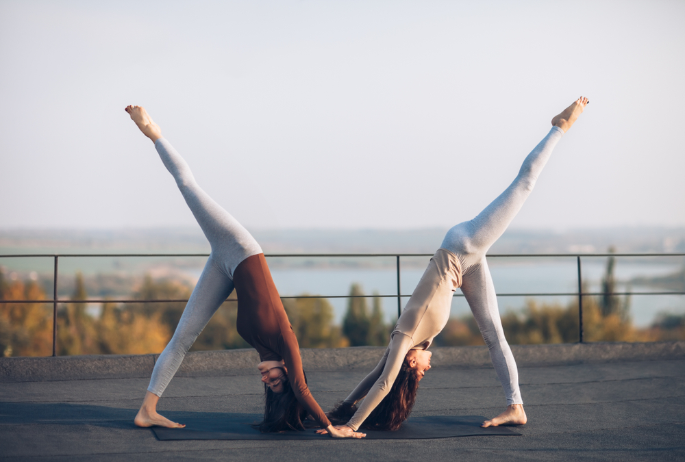 two women doing a yoga pose